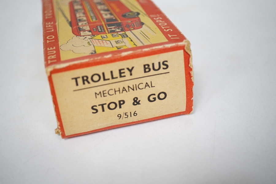 A boxed Wells Brimtoy tinplate clockwork trolley bus loosely in London Transport livery, together with three keys. Condition fair to good, clockwork motor appears to work correctly although has lost grip on the driving a